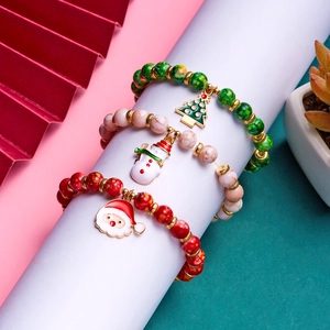 Detailed shot of Christmas beaded bracelets with Santa Claus and snowman charms