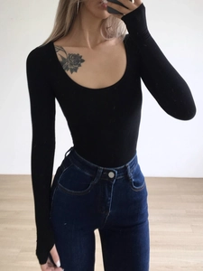 Slim fit black U-neck long sleeve bodysuit paired with high-waisted denim jeans