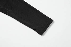 Close-up of black ribbed fabric showing detailed texture and neat double-needle stitching