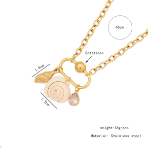 Detail view of 46cm stainless steel gold chain with rotatable shell and conch pendants