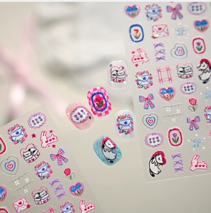 Close-up of embossed nail stickers featuring cute cartoon cats, rabbits and tulip patterns