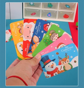 Close-up of colorful Christmas themed gift cards with Santa and reindeer designs