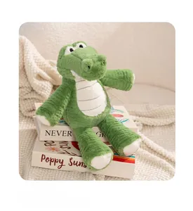 Detail view of the green plush crocodile toy showing textured fabric and white belly