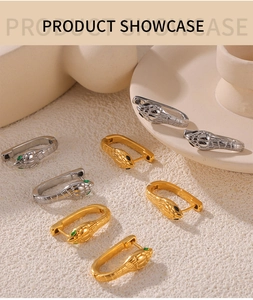 Detailed view of snake head hoop earrings with diamond accents in gold and silver finishes