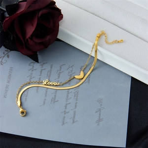 Double-layered gold titanium steel bracelet featuring a heart charm and Love lettering