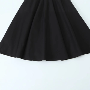 Close-up of black sleeveless mini dress hem featuring fine stitching and smooth fabric