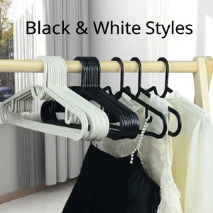 Modern non-slip clothes hangers in black and white plastic with shoulder notches for home use