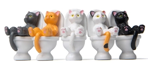Set of five colorful miniature cats sitting on white toilets for desktop landscape decor