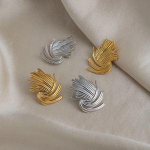 Detailed close-up of textured firework pattern earrings in gold and silver finishes