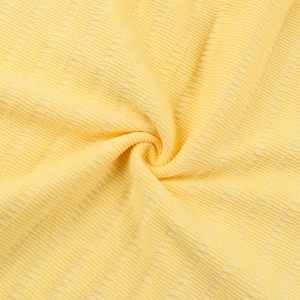 Close-up of yellow ribbed knit fabric showing soft texture and detailed vertical stripes