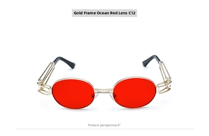 Detail view of steampunk oval red lenses with a slim gold metal frame for chic sun protection