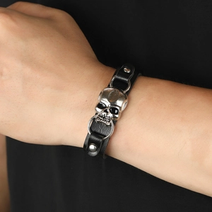 Punk style black leather bracelet with silver skull charm and metal rivets for fashion