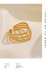Detailed view of layered 18K gold plated V-shape ring with beaded edges on silk