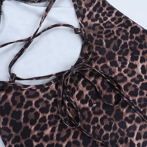 Close-up of leopard print fabric detail with sleek shoulder straps and fine edge stitching