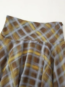 Detail view of plaid skirt waistline featuring invisible side zipper and chiffon texture