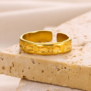 Macro shot of irregular 18k gold plated ring featuring traditional cloud relief patterns