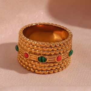 Close-up of vintage 18K gold plated wide ring with red and green natural stones