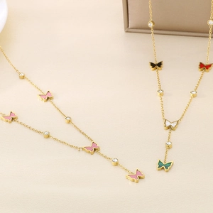 Detail of gold-plated stainless steel necklaces with multi-colored butterfly pendants