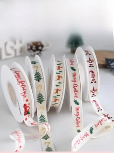 Close-up of Christmas polyester cotton ribbons with elk, tree, and snowflake patterns