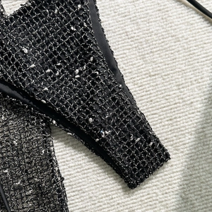 Close-up of black and white mesh texture on three-piece bikini set with intricate weave
