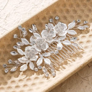 Detailed view of bridal hair comb with silver alloy flowers and sparkling rhinestones