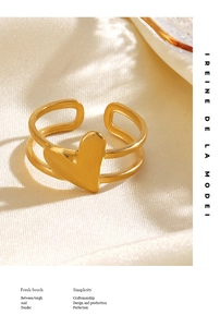 Detailed shot of a gold heart-shaped double-band open ring on premium silk fabric