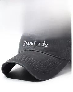 Macro detail of embroidered letters on gray washed cotton baseball cap with structured brim