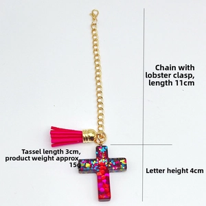 Detail view of colorful resin cross pendant with pink tassel and gold chain dimensions