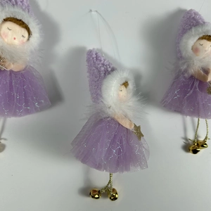 Detailed view of three purple fairy dolls with knit hats and golden bells for Christmas