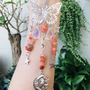 Detail of butterfly suncatcher with colorful stones and faceted rainbow crystal drops