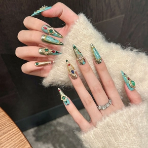Luxury handmade press-on nails featuring heavy rhinestone decor and jewel embellishments