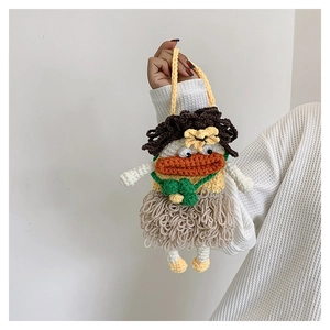 Handmade knitted crochet bag featuring a quirky face with thick orange lips and fringe