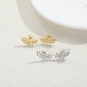 Minimalist leaf-shaped stud earrings set in gold and silver finish with zircon inlay
