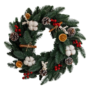 Christmas wreath with pine needles, cones, cotton, and orange slices on white background