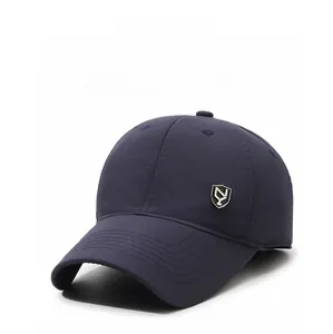 Detail view of winter navy baseball cap with ear protection and metal shield emblem