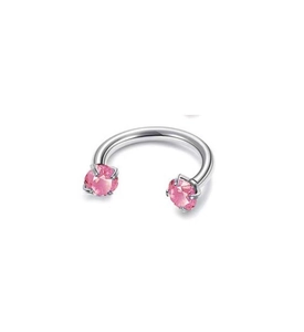 Detailed view of silver F136 titanium horseshoe ring with pink cubic zirconia stones