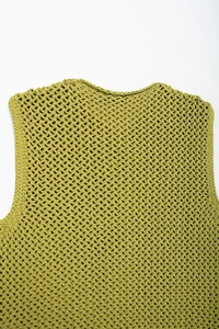 Close-up of yellow-green knit vest showing textured hollow mesh pattern and neckline detail