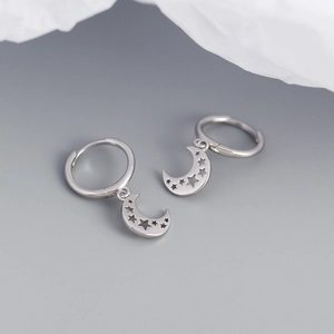 Detail view of S925 silver hoop earrings with hollow star and moon charms