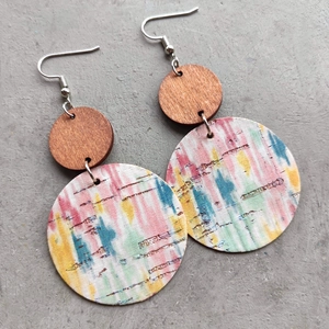 Detail of bohemian round earrings with hand-painted cork pattern and dark brown wood