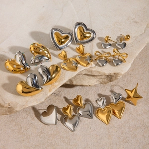 Mixed gold and silver stainless steel heart and star earrings on a stone textured base