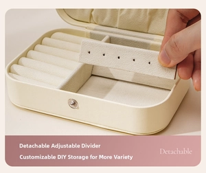 Close-up of portable jewelry box with detachable dividers and cream white leather
