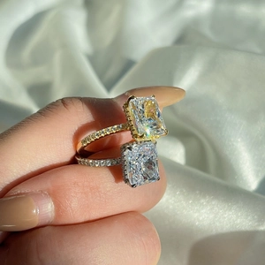 Close-up of gold and silver S925 rings with emerald-cut cubic zirconia stones