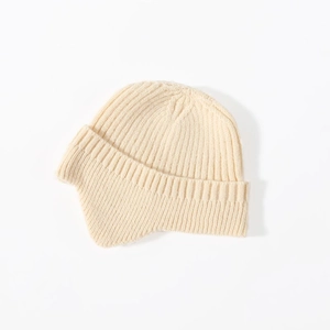 Close-up of beige knit trapper hat showing soft winter-warm wool texture