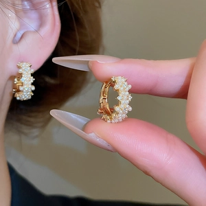 Detail view of 14K gold plated hoop earrings with micro-set zircons and pearls