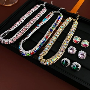 Detail of luxury tennis necklace set with pink and multi-color rhinestones and stud earrings