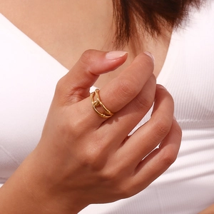 Close-up of a double-layered 18K gold-plated hollow winding ring on a model's finger
