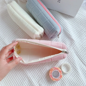 Detailed view of the large capacity velvet pencil case interior with grid pattern fabric