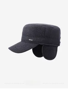 Detail view of winter flat cap showing charcoal gray twill fabric and ear protection
