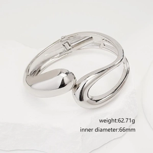 Minimalist irregular silver open bangle on stone with size and weight details