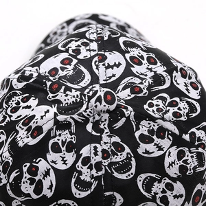 Close-up of baseball cap featuring red-eyed skull prints and detailed twill cotton texture